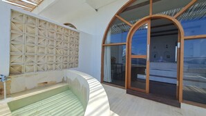 A modern architectural design with a pool, arched windows, and a geometric wall pattern.