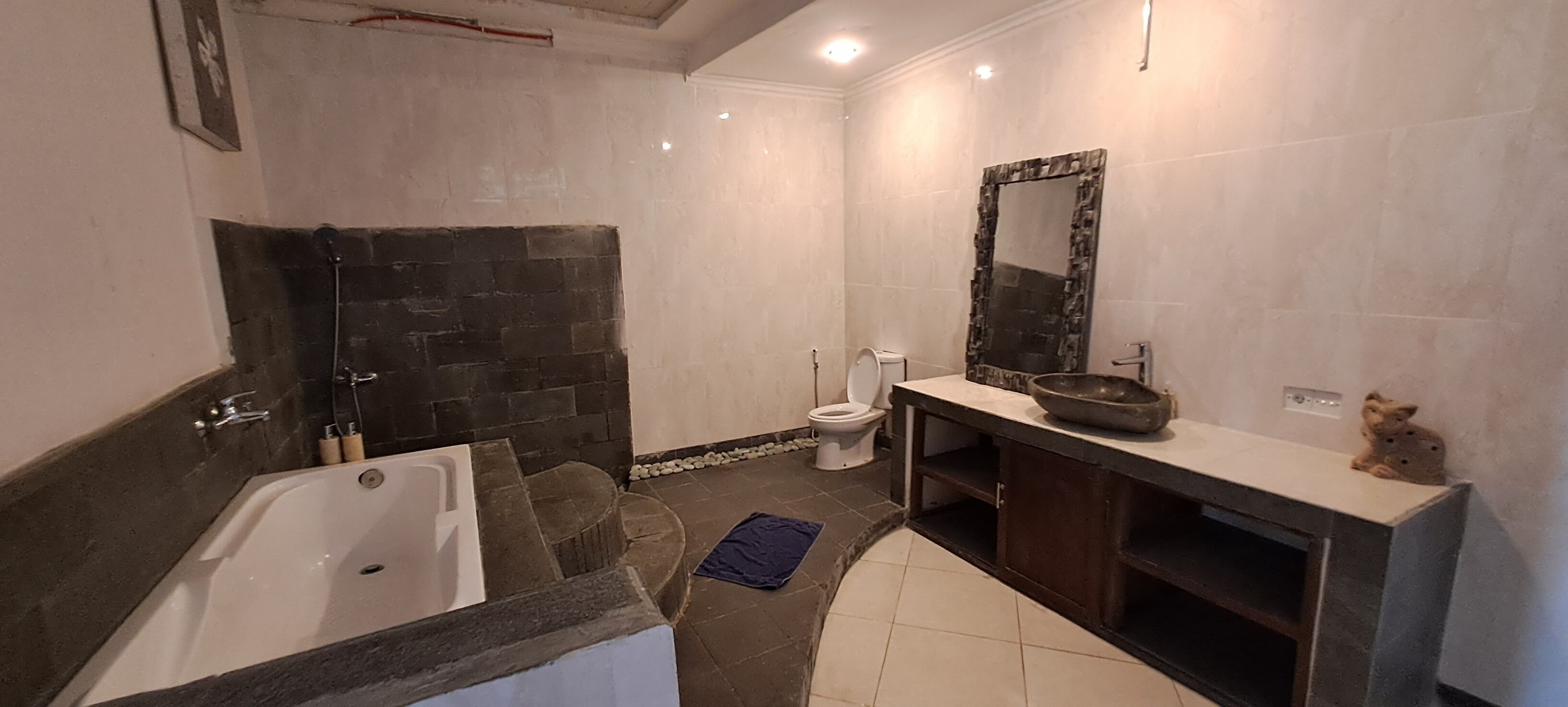A bathroom with a bathtub, toilet, and sink.