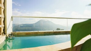 A pool with a view of a mountain.