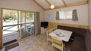 Deluxe Cabin | Living area | 36-inch flat-screen TV with digital channels, TV, DVD player