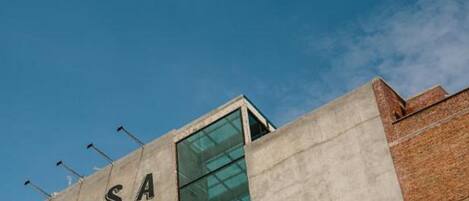 A building with a sign reading "ROSA" and a glass facade.