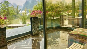 A balcony with a view of mountains and greenery. - Moonlit Sky Resort (Guilin)