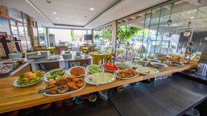 A buffet setup with various dishes and a modern interior. - Lidya City Hotel (Fethiye)