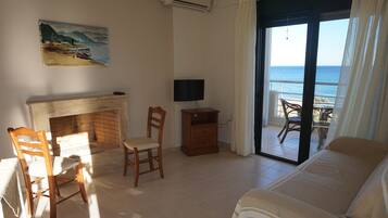 Comfort Suite, 1 Bedroom, Sea View (2nd Floor) | Living room | 43-inch Smart TV with satellite channels