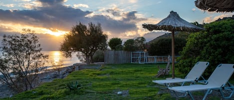On the beach, sun loungers, beach umbrellas