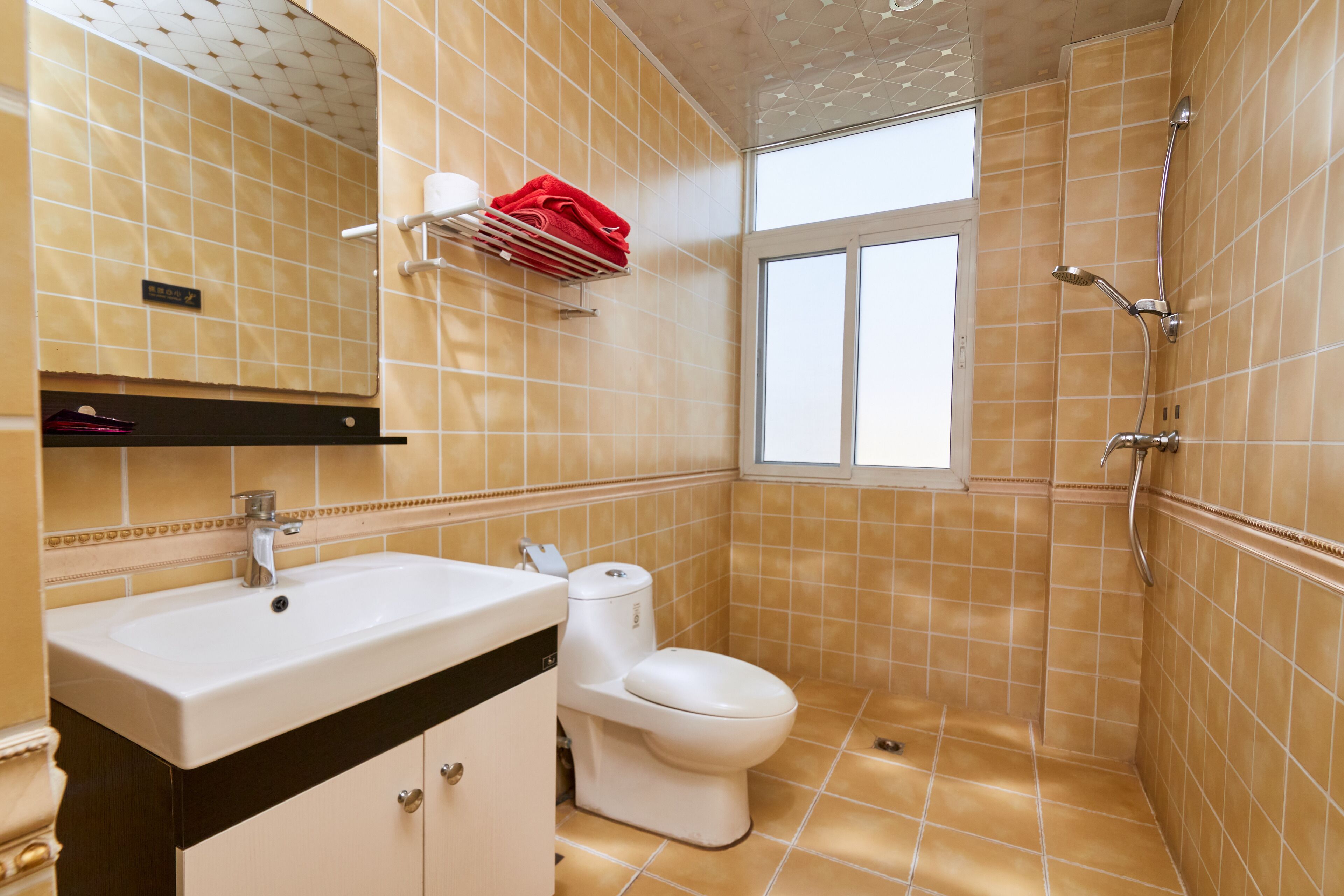 A bathroom with a sink, toilet, and shower.