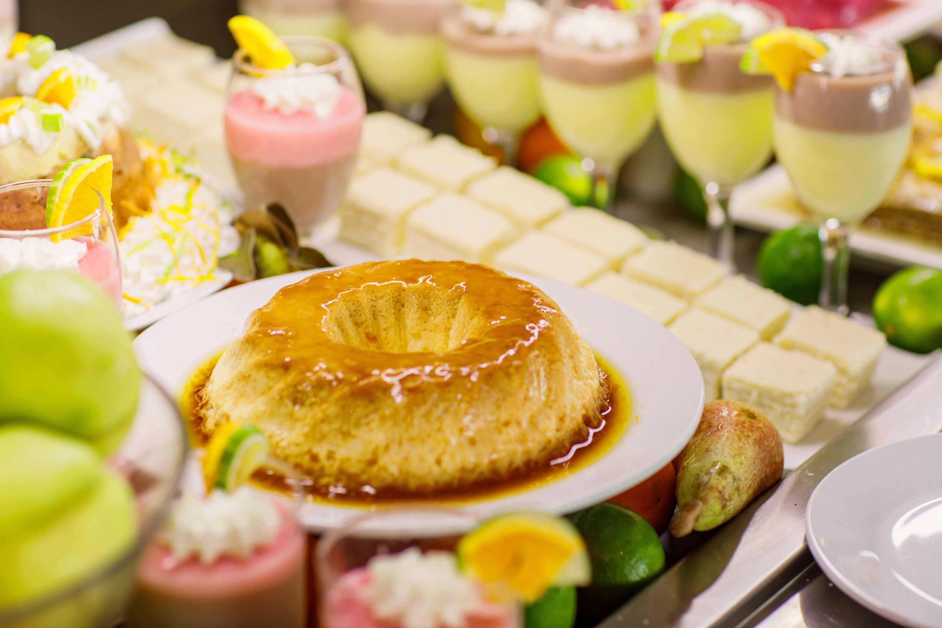 A dessert table with various sweet treats and drinks.