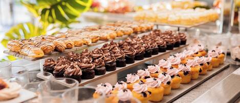A variety of pastries and desserts displayed on trays.