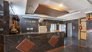 A reception desk with a sign reading "VIJAYA RESIDENCY". - Itsy Hotels Vijaya Residency (Udupi)