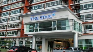 A multi-story hotel named "The Star" with a modern facade, large windows, and a visible entrance area.