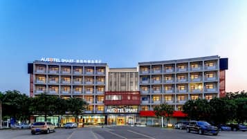 A multi-story hotel with a prominent signage for "AUSOTEL SMART".