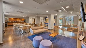 A modern hotel lobby with a bar area, seating arrangements, and a reception desk. - City Express by Marriott Celaya Galerias (Celaya)