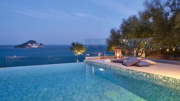 A swimming pool with a view of the sea and a small island. - Avra Luxury Villa (Zakynthos)