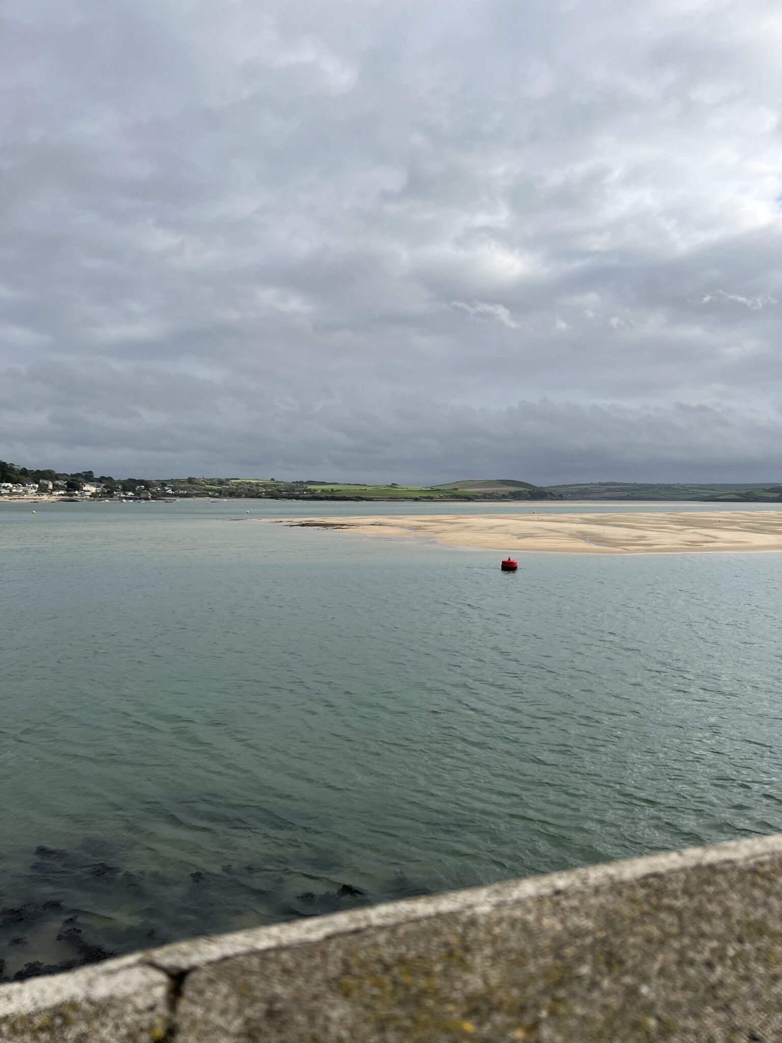 A coastal view with a sandy beach and calm waters.