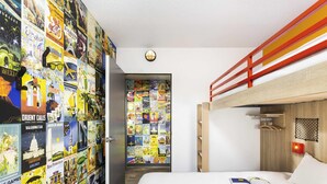 A hotel room with a bunk bed, a wall decorated with travel posters, a round light fixture, and a wooden headboard. - hotelF1 Avranches Baie du Mont Saint Michel (Saint-Quentin-sur-le-Homme)