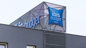 A modern building with a sign reading "ibis budget hotels" on the facade.