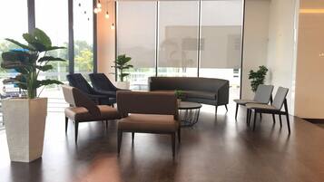 A modern interior with a sofa, chairs, and a coffee table.