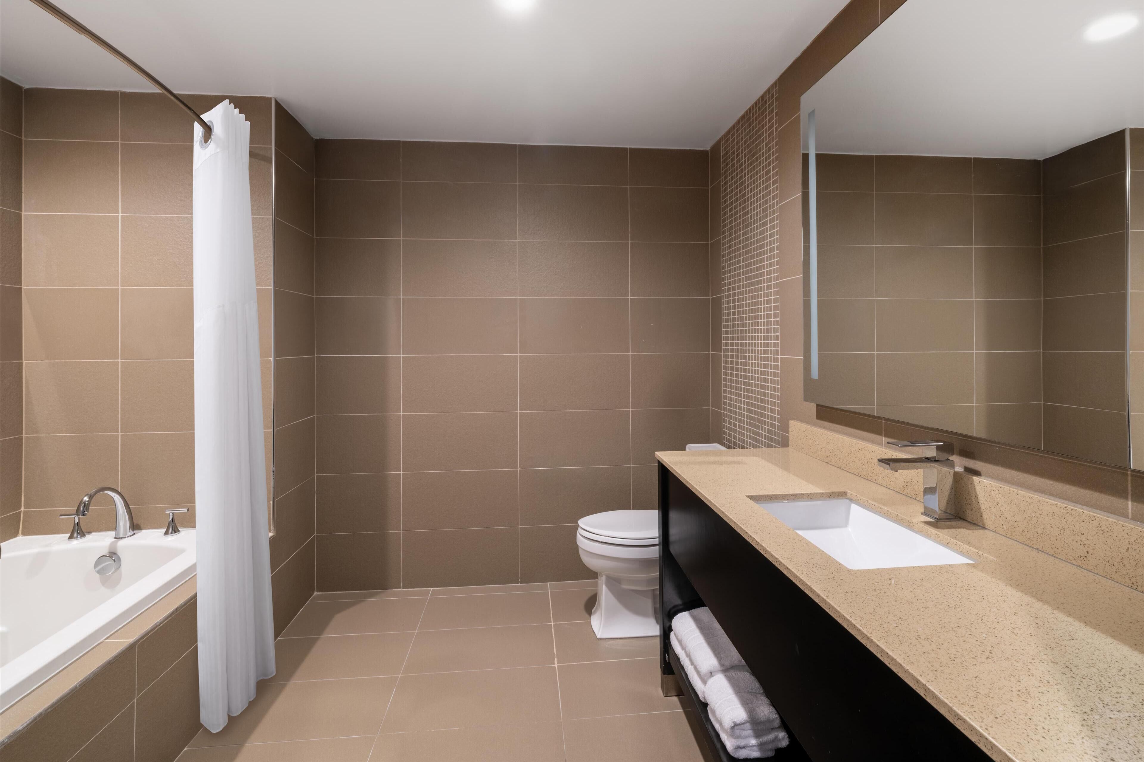 suite, 1 king bed, non smoking, refrigerator & microwave (with sofabed) | bathroom | combined shower/bathtub, free toiletries, hair dryer, towels