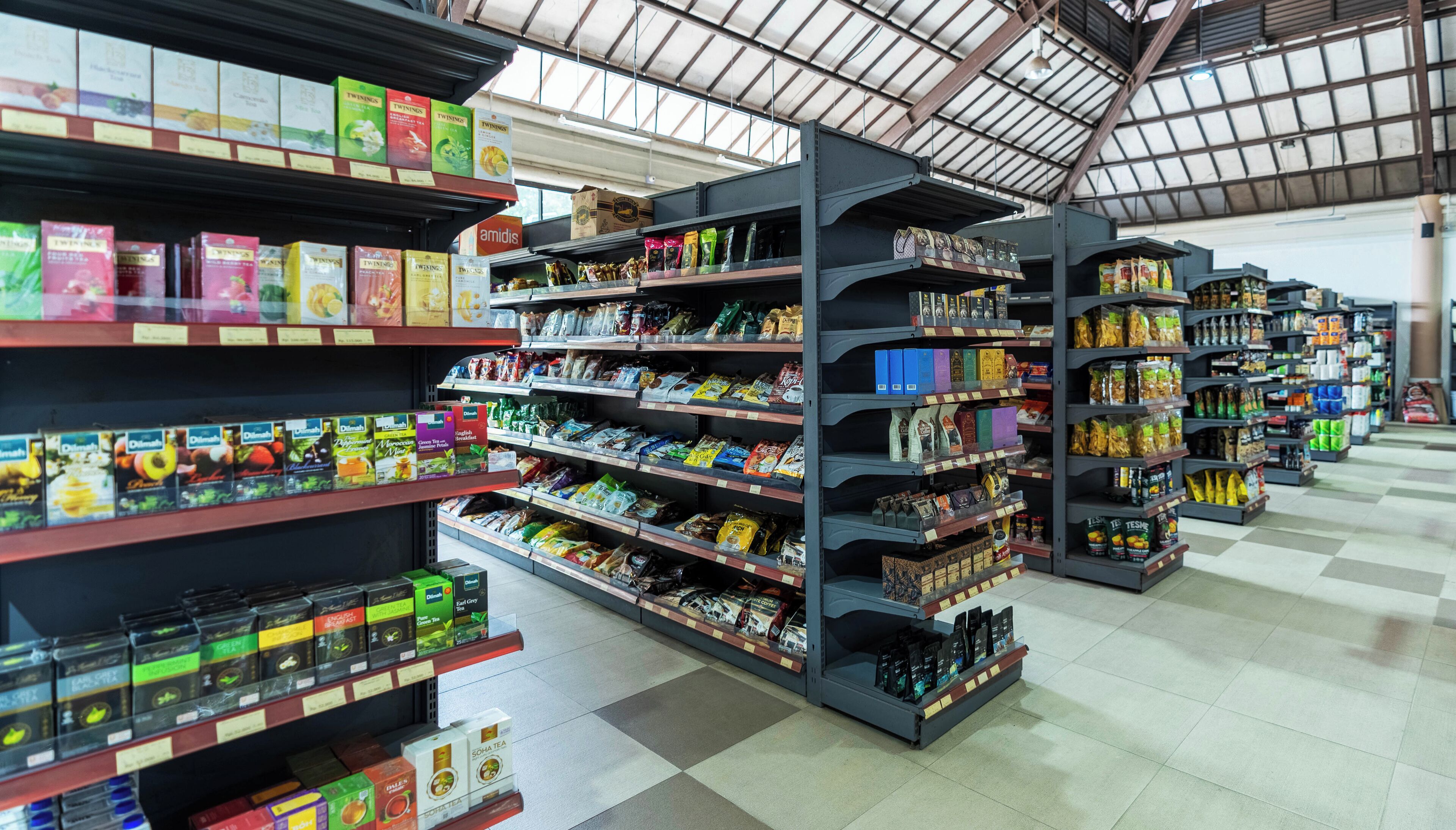 A grocery store aisle with shelves stocked with various food products.
