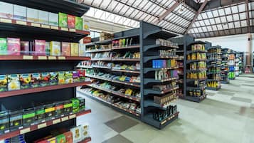 A grocery store aisle with shelves stocked with various food products.