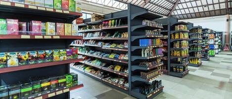 A grocery store aisle with shelves stocked with various food products.