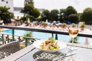 Enjoy a romantic dinner for two on the balcony overlooking the pool and lush surroundings.
