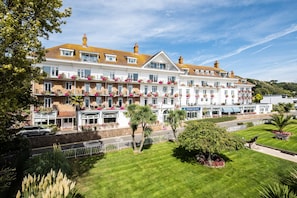 Stunning hotel with a traditional facade, featuring evenly spaced windows and balconies with flower boxes.