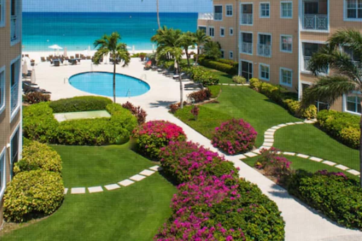 A resort with a pool, beach, and ocean view.