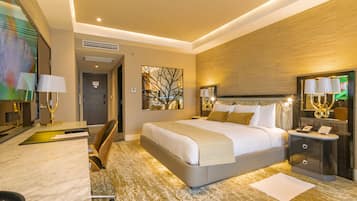 A modern hotel room with a large bed, a desk, and a chair.