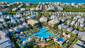 An aerial view of a resort with multiple buildings, a central pool, and a view of the ocean. - Villas of Seacrest Beach on 30A by Panhandle Getaways (Panama City Beach)