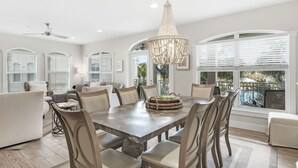 A spacious dining area with a large table, multiple chairs, and a chandelier. - Villas of Seacrest Beach on 30A by Panhandle Getaways (Panama City Beach)