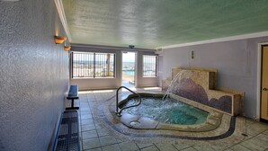 A spa area with a hot tub, seating, and a view of the outdoors. - Regency Towers Beach Resort by Panhandle Getaways (Panama City Beach)