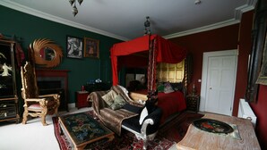 A traditional room with a four-poster bed, a fireplace, and ornate furniture. - The Covenstead (Glastonbury)