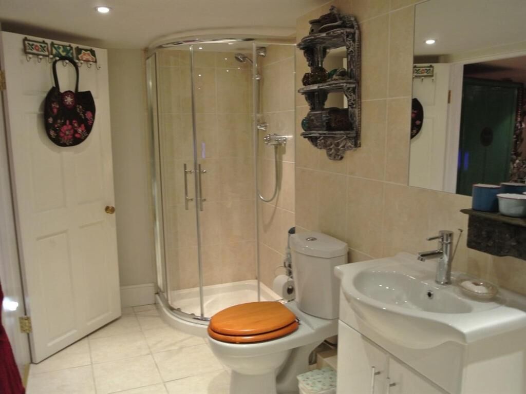 A bathroom with a shower, toilet, and sink.
