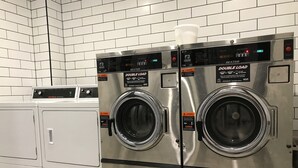 A commercial laundry facility with two double-load stainless steel front-loading washers and a single top-loading washer. - Down Under Hostels - Surfers Paradise (Surfers Paradise)