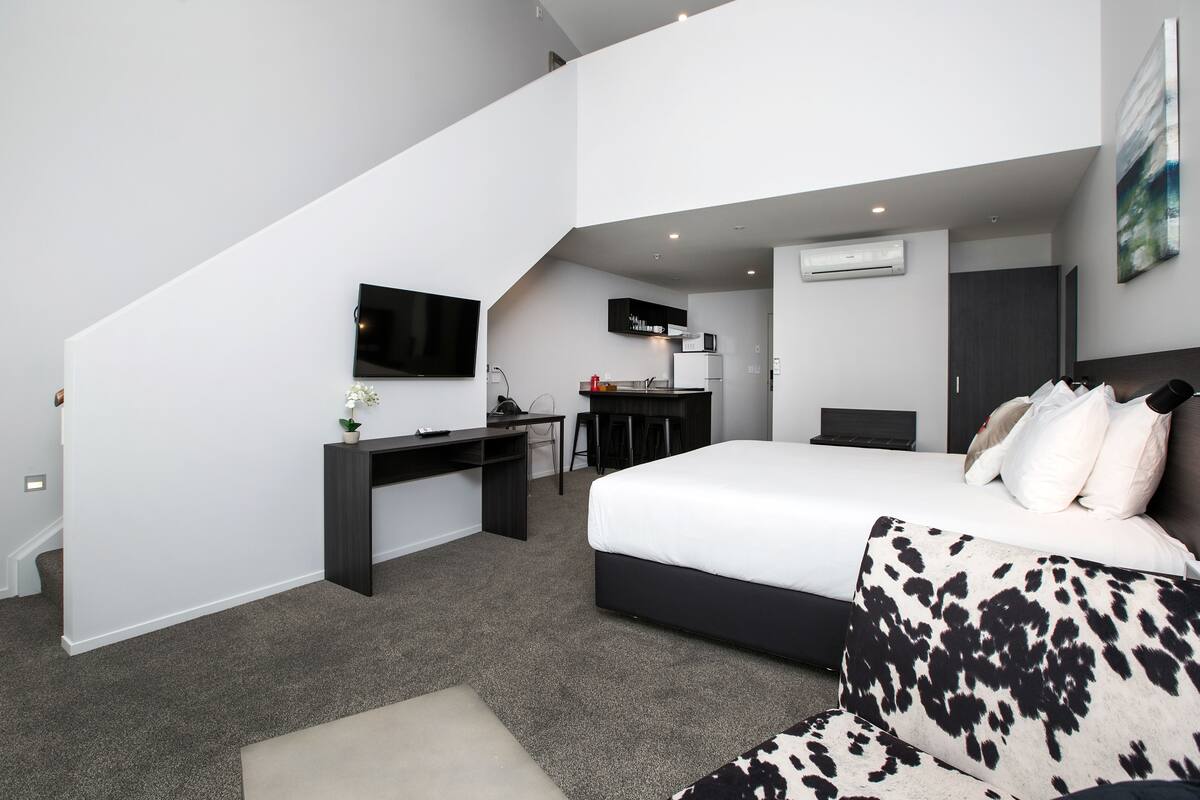 Premium bedding, desk, laptop workspace, blackout curtains