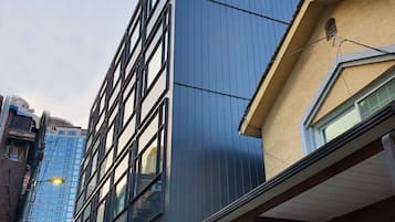 A modern building with a prominent 'YOLO' sign on the facade, featuring a mix of glass and metal construction.