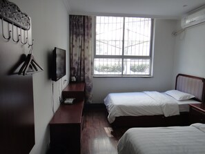 A bedroom with two beds, a TV, a desk, and a window with curtains. - Xi'an The Facebook Youth Hostel (Xi'an)