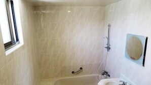 A bathroom with a bathtub, a sink, and a shower. - Nice Hotel (Taipei)