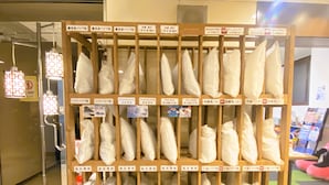 A display of packaged goods in a retail setting with wooden shelving and labels in a foreign language. - A-Gate Hotel (Hakodate)