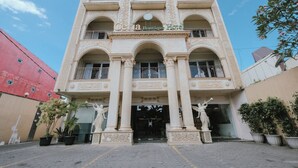A building with a sign reading "Ceria Boutique Hotel" and a statue in front. - Ceria Boutique Hotel (Depok)