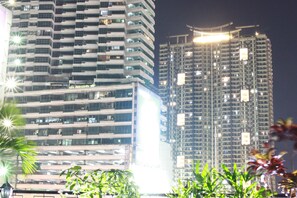 A high-rise building with multiple floors, large windows, and balconies. - Frederick's Apartelle (Mandaluyong)