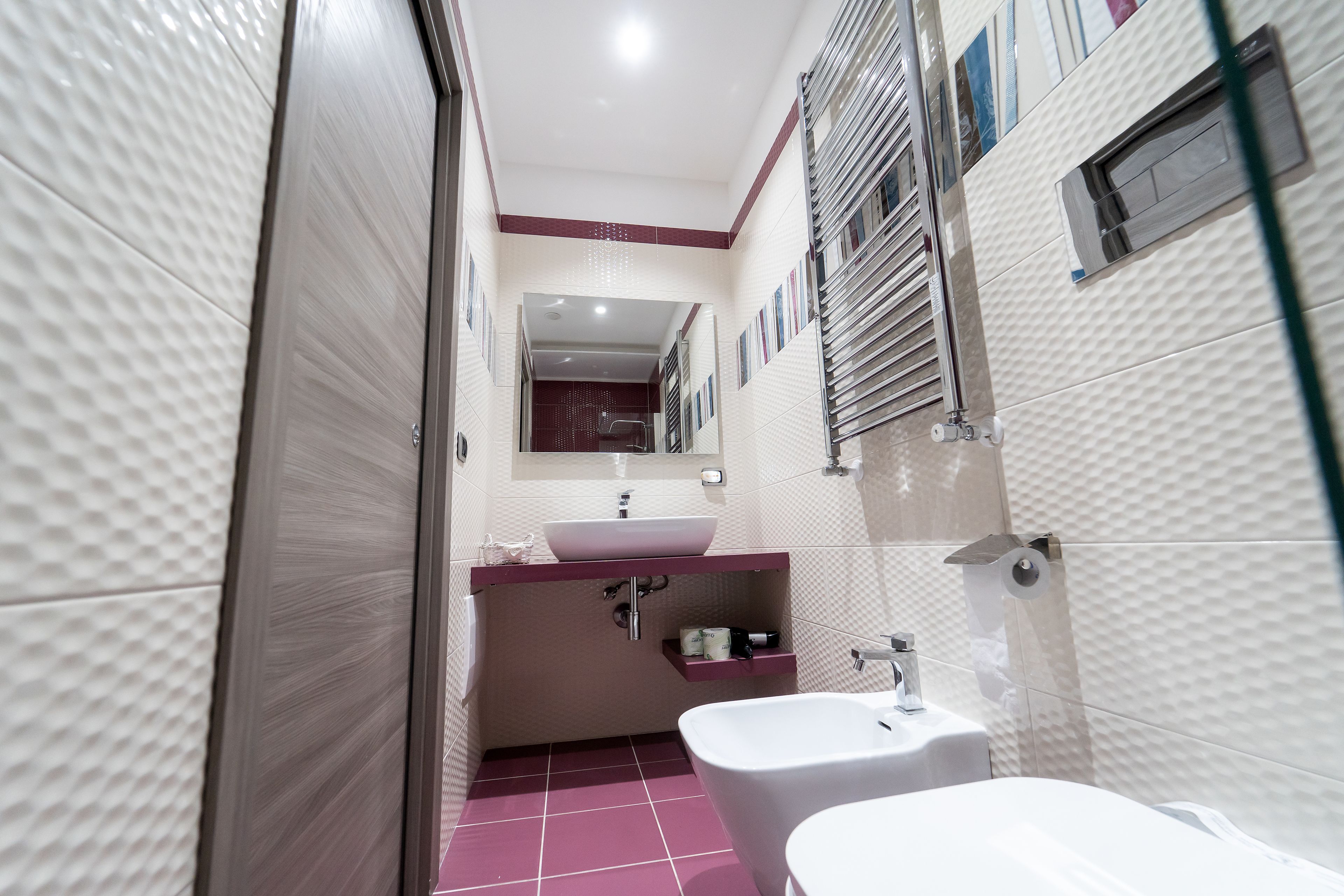 A modern bathroom with a vanity, sink, and bathtub.