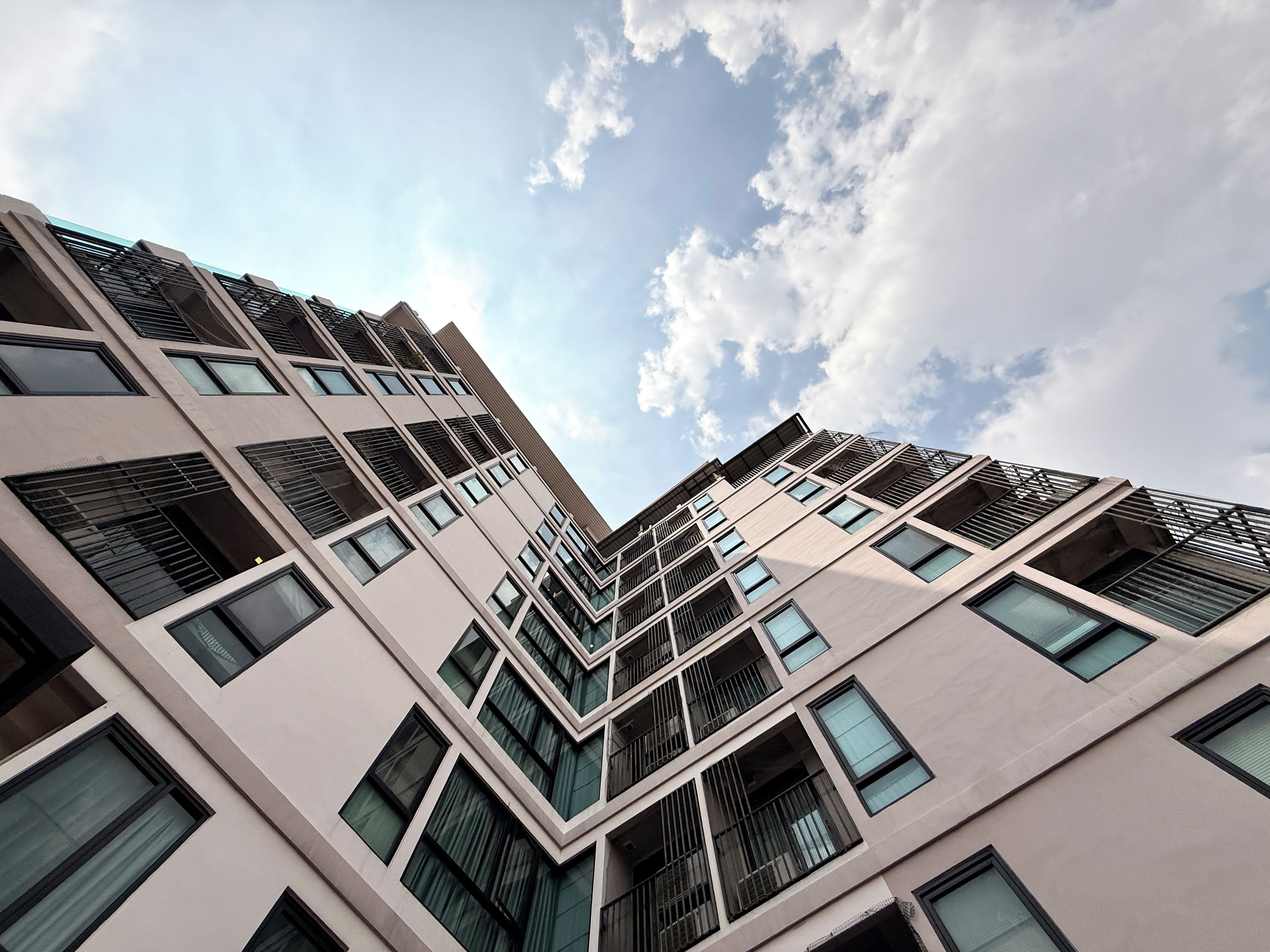 A modern building with a geometric facade and multiple windows.
