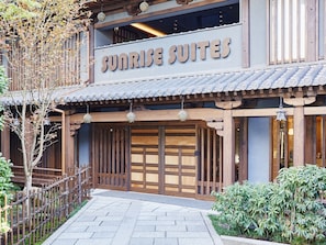 A traditional Japanese-style building with a sign reading "Sunrise Suites". - Sunrise Suites (Kyoto)