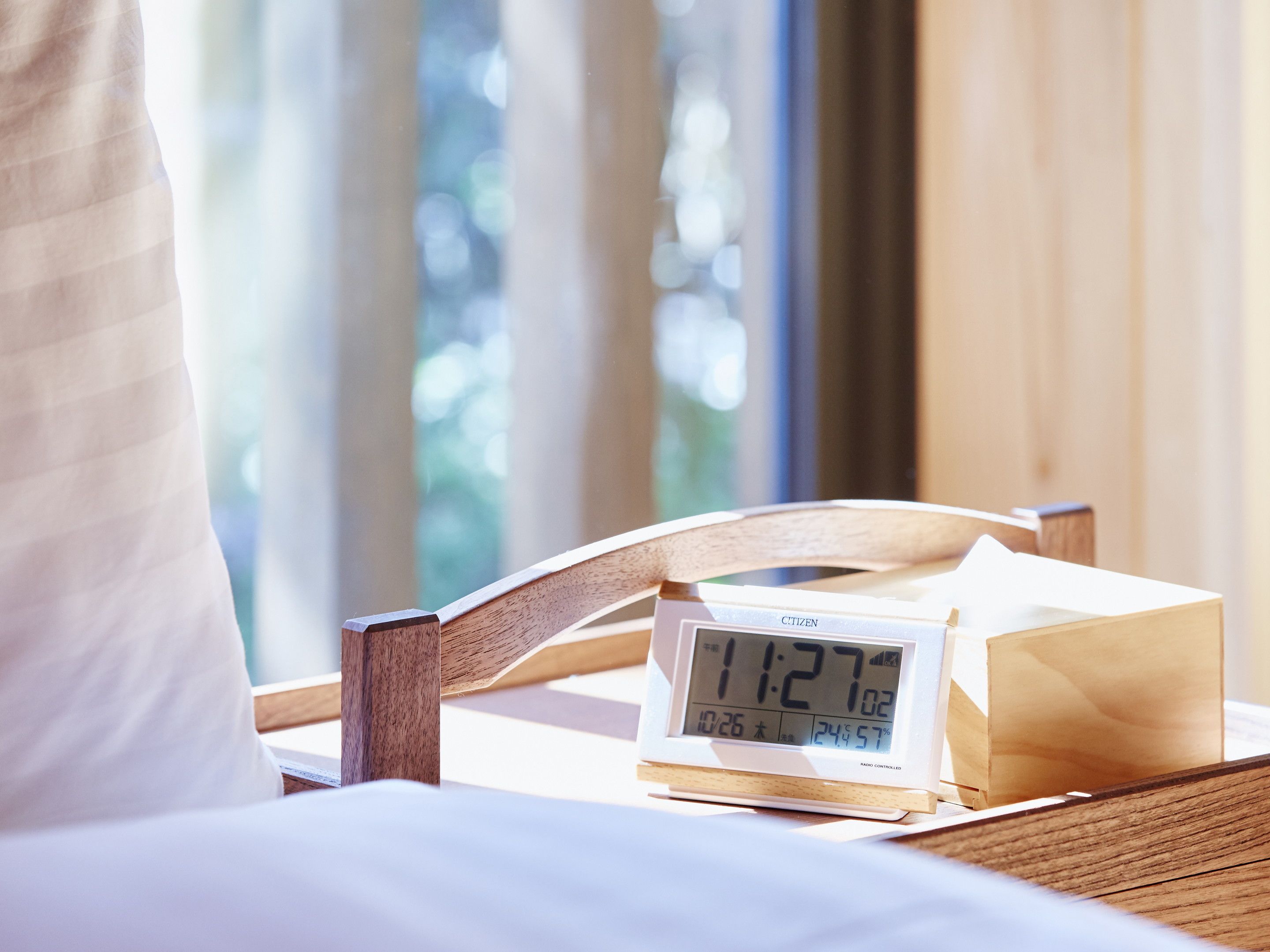 A wooden chair with a digital clock displaying the time.