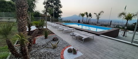 Seasonal outdoor pool, open 9:00 AM to 7:00 PM, pool umbrellas