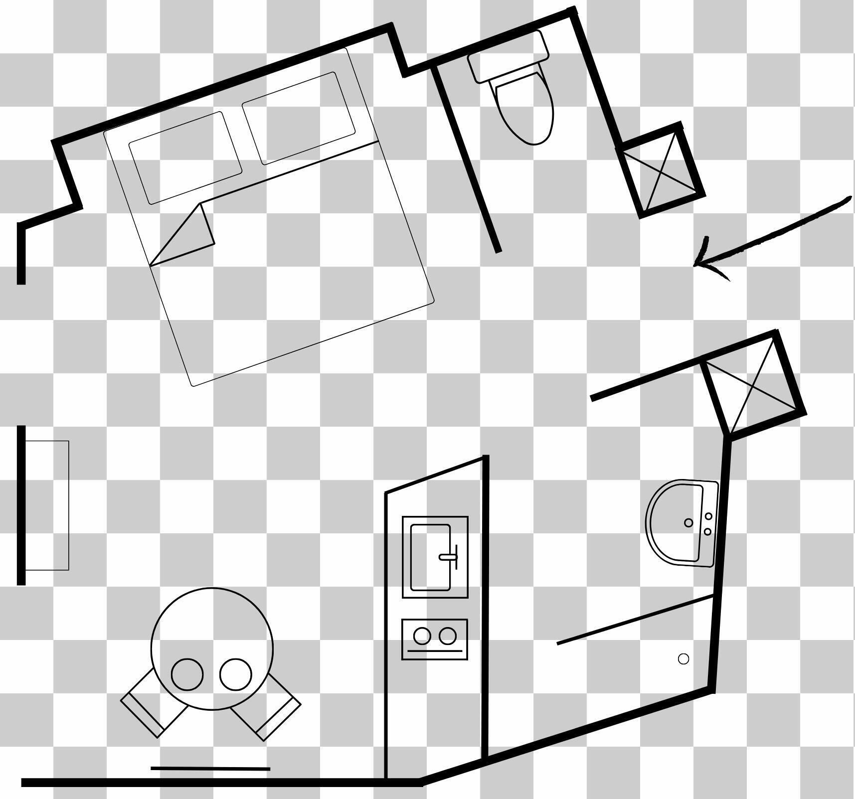 Een hotelkamer met een bed, een bureau, een stoel, een toilet en een wastafel.