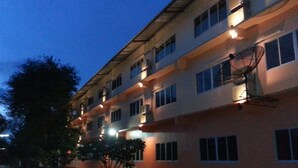 A multi-story building with multiple windows and balconies, likely a hotel or apartment complex. - Budsarakam Place Hotel (Chanthaburi)