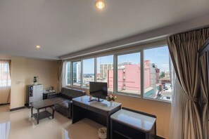 Quadruple Room | Living area | 32-inch flat-screen TV with cable channels, TV - The Grand Day Night (Pattaya)